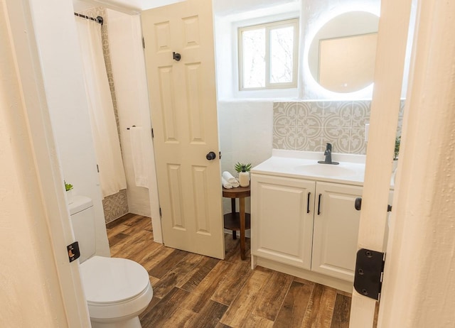 full bath featuring vanity, toilet, and wood finished floors