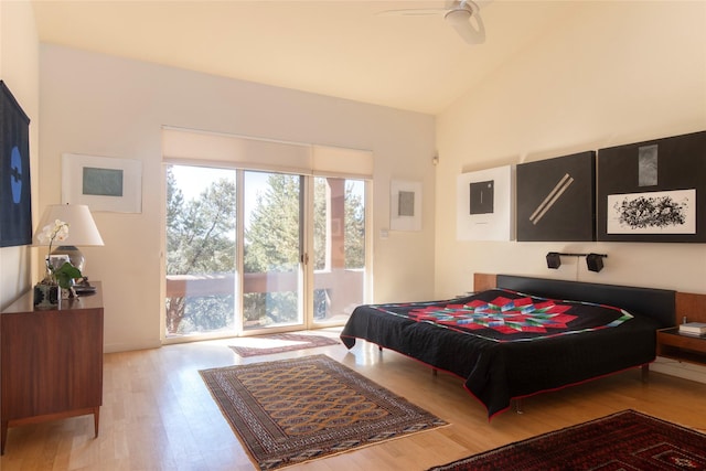 bedroom featuring ceiling fan, wood finished floors, lofted ceiling, and access to outside