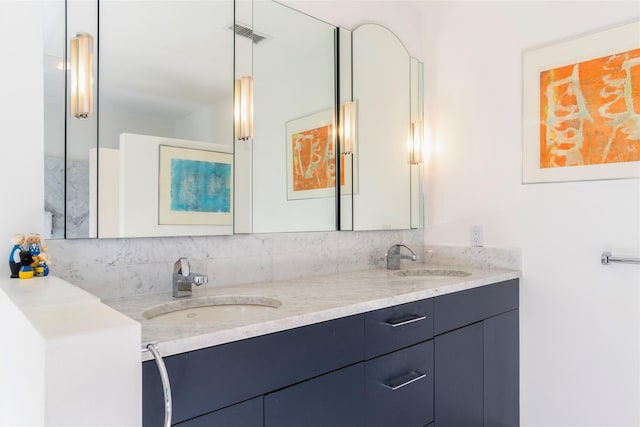 full bathroom with a sink, visible vents, and double vanity