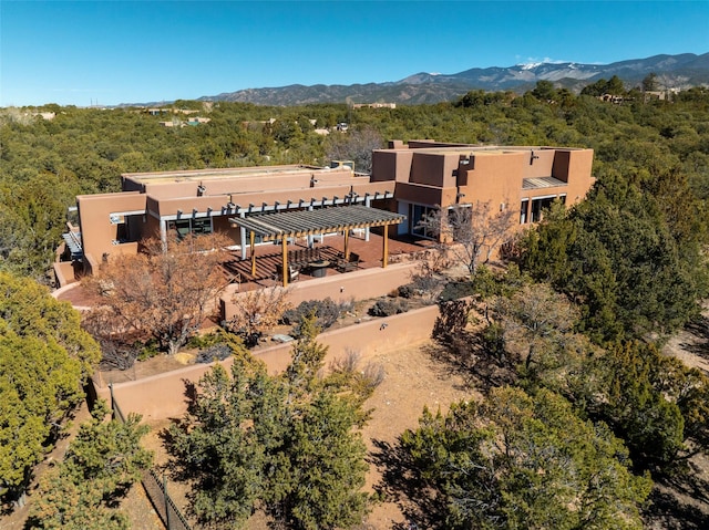 birds eye view of property with a forest view and a mountain view