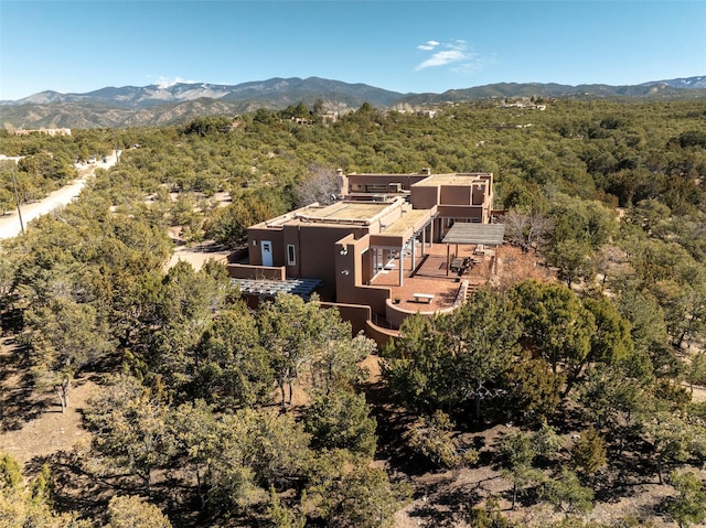 aerial view with a mountain view and a view of trees