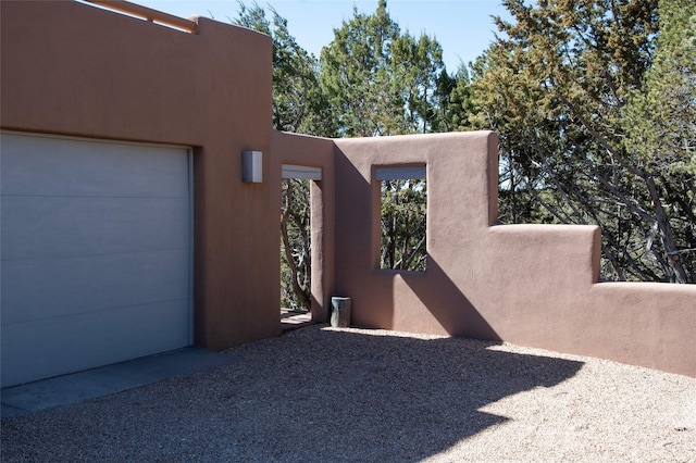 view of property exterior featuring stucco siding and a garage