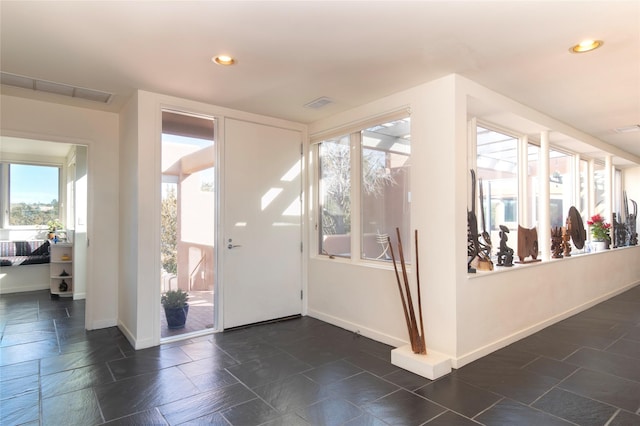 interior space with recessed lighting, visible vents, baseboards, and stone tile floors