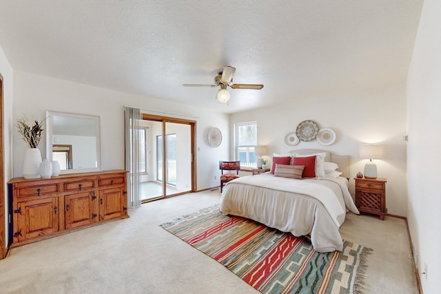 bedroom featuring light carpet, access to outside, baseboards, and ceiling fan