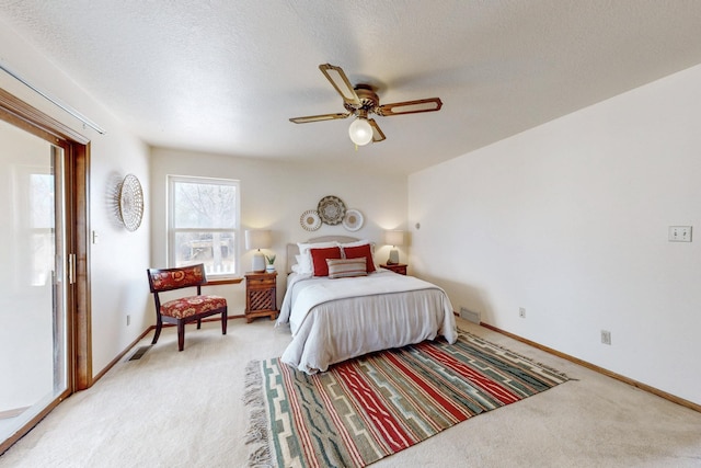 bedroom featuring visible vents, baseboards, a ceiling fan, and light carpet