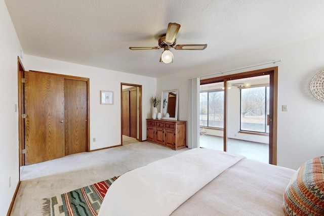 bedroom with light colored carpet, baseboards, and a ceiling fan
