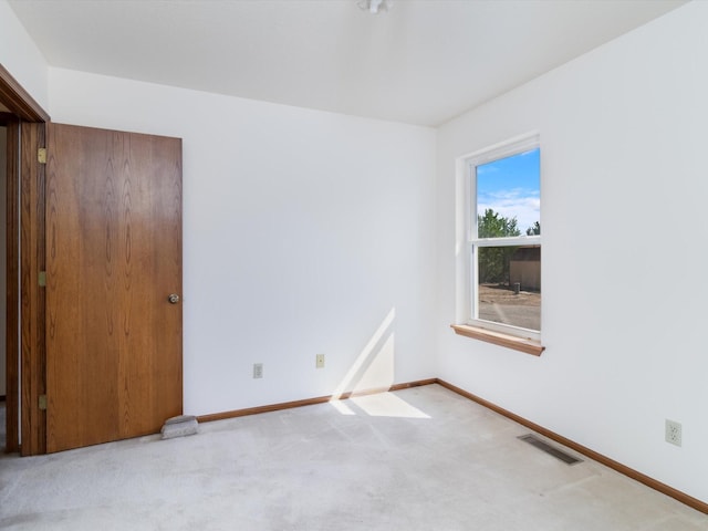 spare room featuring visible vents, baseboards, and carpet floors