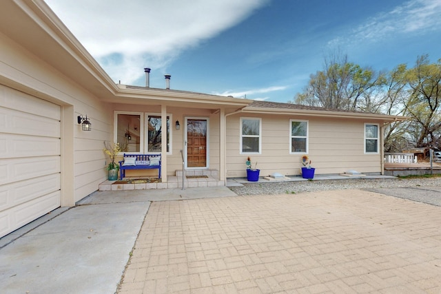 entrance to property with a porch and a garage