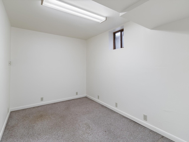 empty room featuring carpet flooring and baseboards