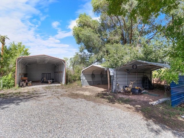 exterior space featuring a detached carport and gravel driveway