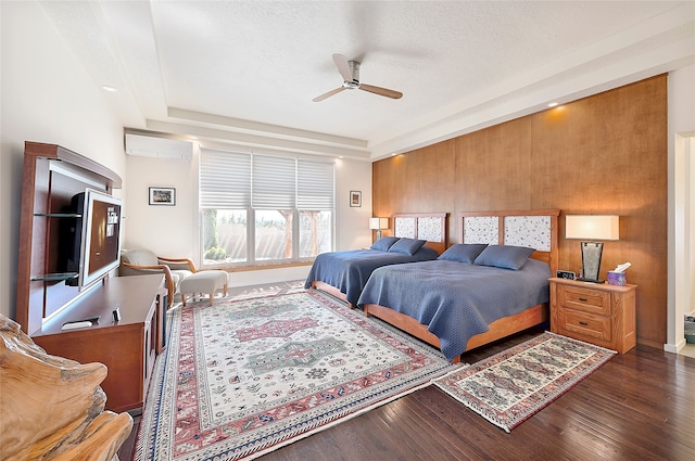 570 Via Arista, Santa Fe, NM 87506 - bedroom with a textured ceiling, a wall mounted AC, ceiling fan, and wood finished floors