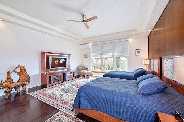 570 Via Arista, Santa Fe, NM 87506 - bedroom featuring ceiling fan, a wall mounted air conditioner, a tray ceiling, and wood finished floors