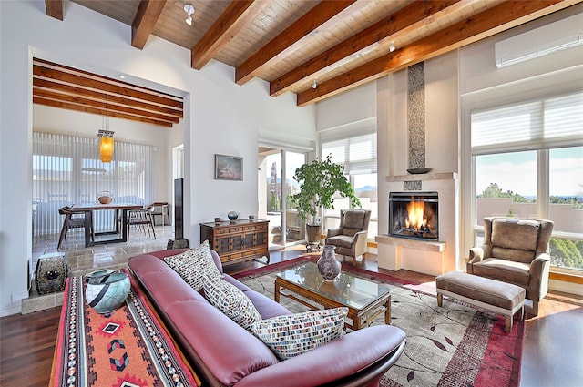 570 Via Arista, Santa Fe, NM 87506 - living area with wooden ceiling, a fireplace, a wealth of natural light, and beam ceiling