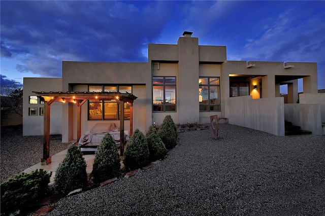 570 Via Arista, Santa Fe, NM 87506 - back of house featuring a patio area, a pergola, and stucco siding