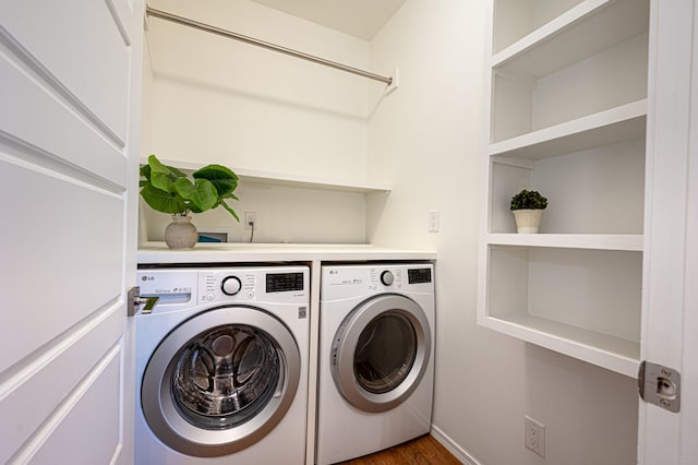laundry room featuring baseboards, laundry area, dark wood-type flooring, and washing machine and clothes dryer