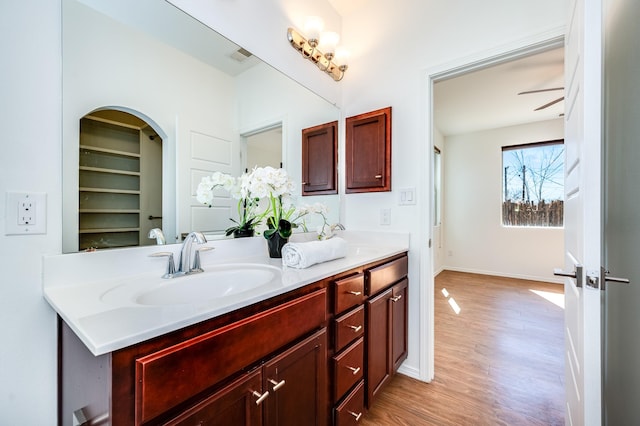 empty room featuring visible vents, baseboards, ceiling fan, and wood finished floors