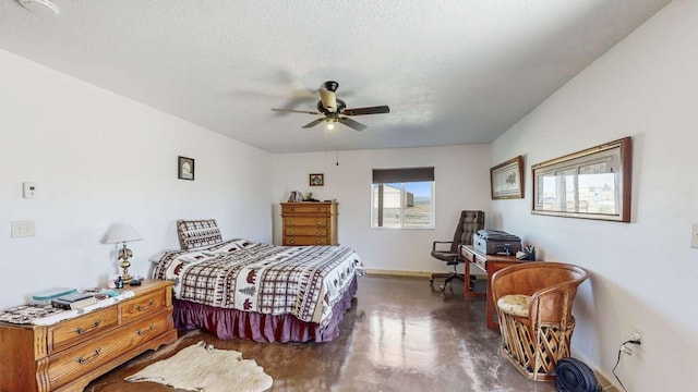 bedroom with a textured ceiling, ceiling fan, baseboards, and finished concrete floors