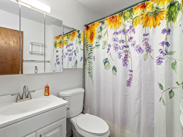 bathroom featuring curtained shower, toilet, and vanity