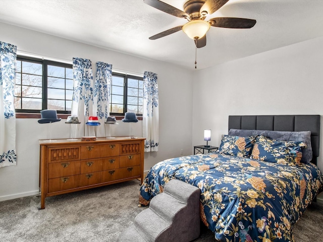 carpeted bedroom with ceiling fan, a textured ceiling, and baseboards