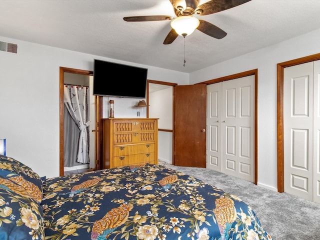 carpeted bedroom featuring baseboards, visible vents, and ceiling fan
