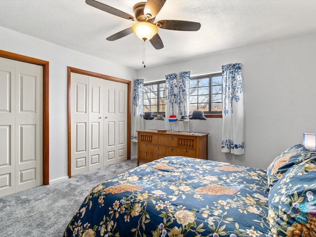 carpeted bedroom with a ceiling fan and a textured ceiling