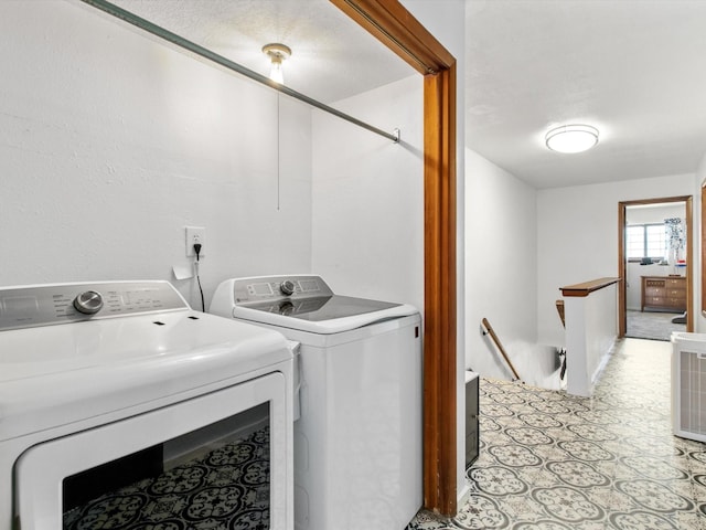 washroom with washer and clothes dryer and laundry area