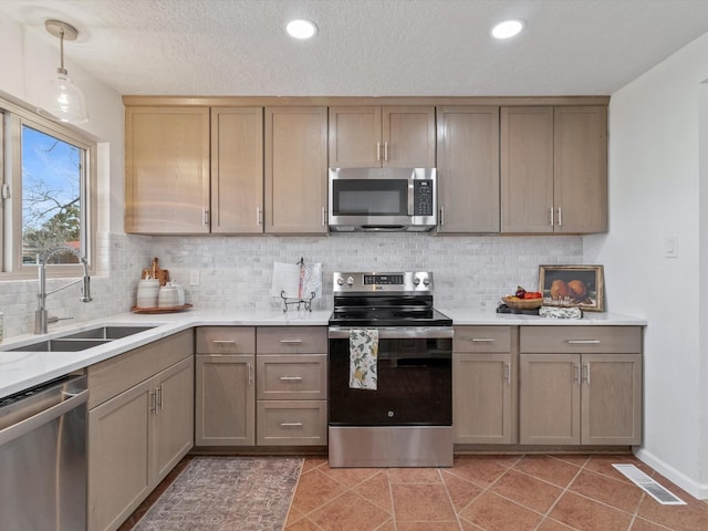 2606 Alamosa Dr, Santa Fe, NM 87505 - kitchen featuring light countertops, visible vents, stainless steel appliances, a sink, and light tile patterned floors