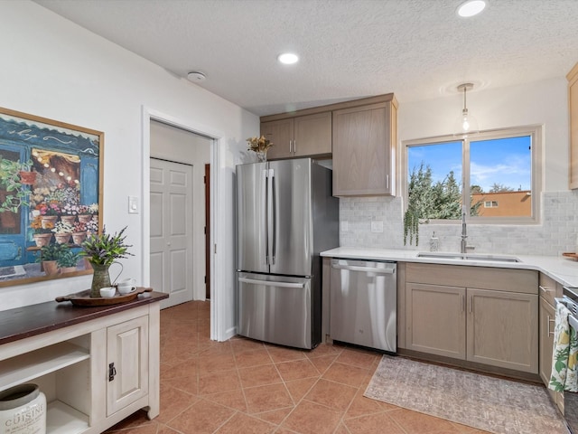 2606 Alamosa Dr, Santa Fe, NM 87505 - kitchen featuring light countertops, light tile patterned floors, stainless steel appliances, decorative backsplash, and a sink