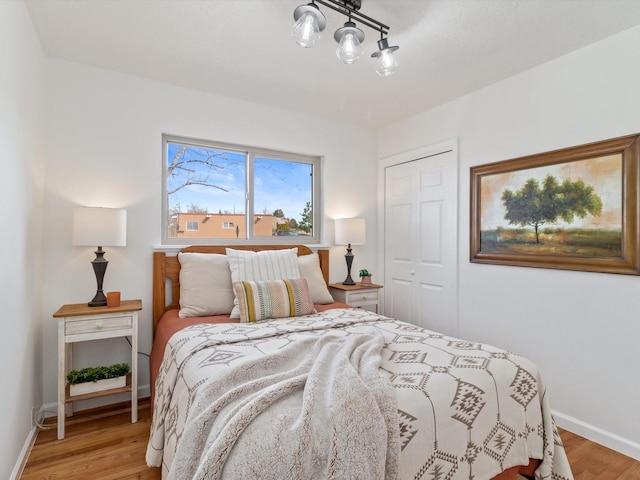 2606 Alamosa Dr, Santa Fe, NM 87505 - bedroom featuring a closet, baseboards, and light wood finished floors
