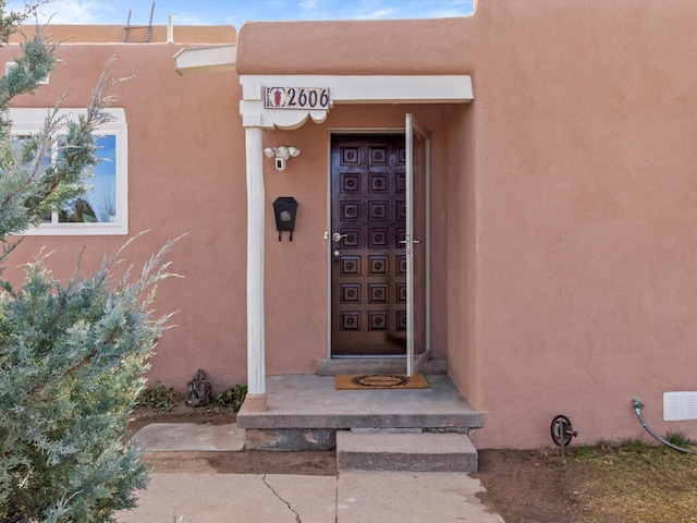 2606 Alamosa Dr, Santa Fe, NM 87505 - entrance to property featuring stucco siding and visible vents