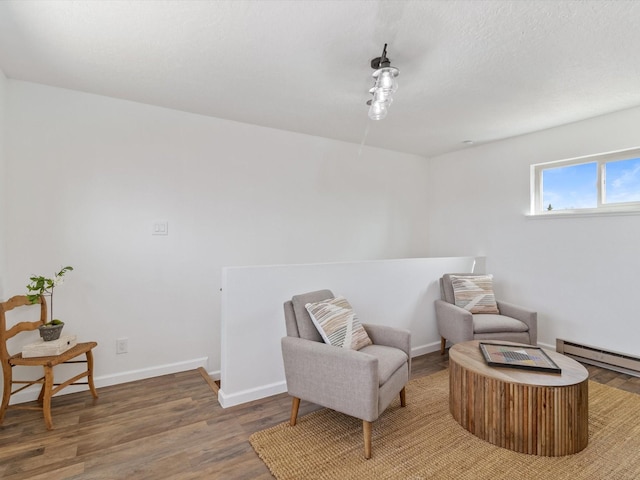 2606 Alamosa Dr, Santa Fe, NM 87505 - sitting room with a baseboard radiator, a textured ceiling, baseboards, and wood finished floors
