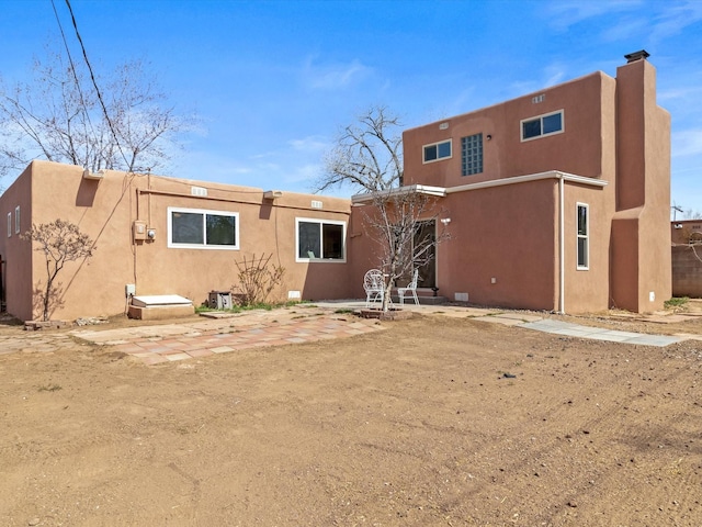 2606 Alamosa Dr, Santa Fe, NM 87505 - rear view of property featuring stucco siding and a patio
