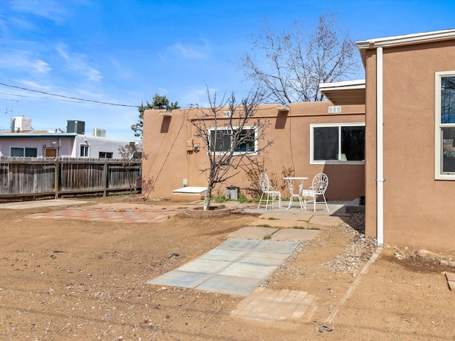 2606 Alamosa Dr, Santa Fe, NM 87505 - rear view of house featuring stucco siding, fence, and a patio area