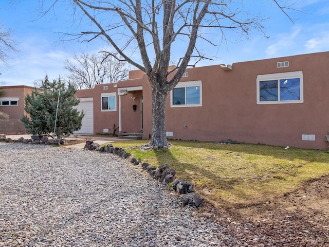 2606 Alamosa Dr, Santa Fe, NM 87505 - adobe home featuring crawl space, a front lawn, and an attached garage