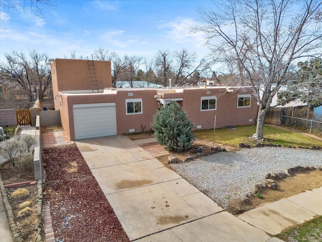 2606 Alamosa Dr, Santa Fe, NM 87505 - exterior space featuring a gate, concrete driveway, stucco siding, fence, and a garage