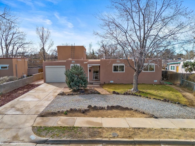 2606 Alamosa Dr, Santa Fe, NM 87505 - southwest-style home featuring stucco siding, fence, driveway, a front yard, and a garage