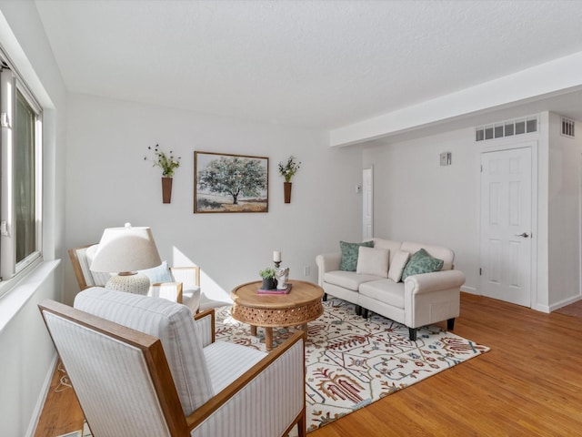 2606 Alamosa Dr, Santa Fe, NM 87505 - living area featuring wood finished floors, baseboards, and visible vents