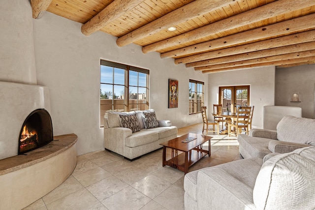 23 Camino Botanica, Santa Fe, NM 87507 - living room featuring french doors, light tile patterned floors, a large fireplace, wood ceiling, and beam ceiling