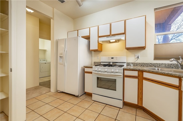 9 E Saddleback Mesa, Santa Fe, NM 87508 - kitchen featuring white appliances, washer / clothes dryer, under cabinet range hood, a sink, and white cabinets