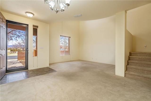 9 E Saddleback Mesa, Santa Fe, NM 87508 - foyer entrance with carpet flooring, a chandelier, plenty of natural light, and stairway