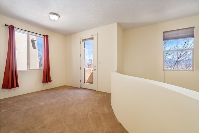 9 E Saddleback Mesa, Santa Fe, NM 87508 - hallway featuring carpet flooring and a textured ceiling
