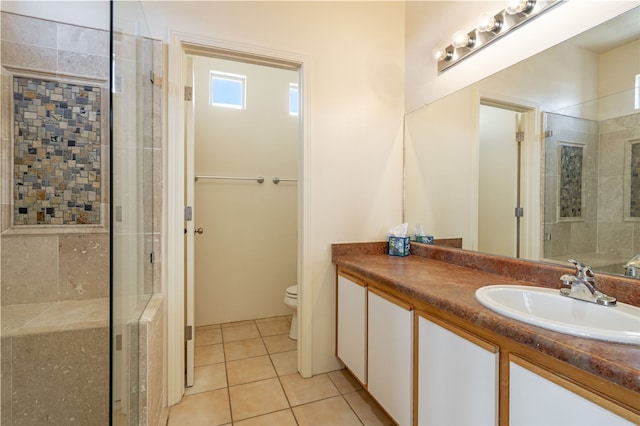 9 E Saddleback Mesa, Santa Fe, NM 87508 - bathroom with a shower stall, toilet, vanity, and tile patterned floors