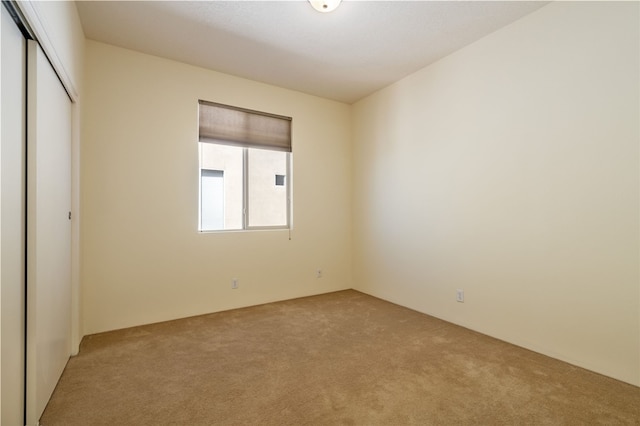 9 E Saddleback Mesa, Santa Fe, NM 87508 - unfurnished bedroom featuring light carpet and a closet