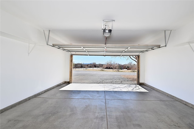 9 E Saddleback Mesa, Santa Fe, NM 87508 - garage with baseboards and a garage door opener