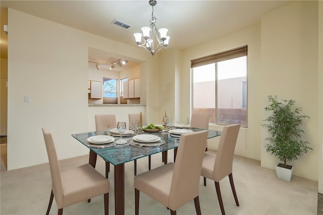 9 E Saddleback Mesa, Santa Fe, NM 87508 - dining room featuring a chandelier and light carpet