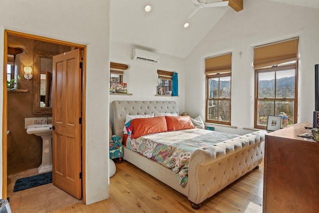 75A Camino Chupadero, Santa Fe, NM 87506 - bedroom with high vaulted ceiling, light wood-type flooring, a wall unit AC, and recessed lighting