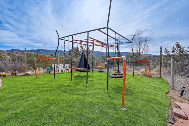 75A Camino Chupadero, Santa Fe, NM 87506 - view of jungle gym with a lawn, a mountain view, and fence