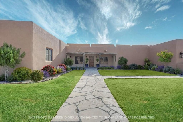 view of front of house featuring a front lawn and stucco siding