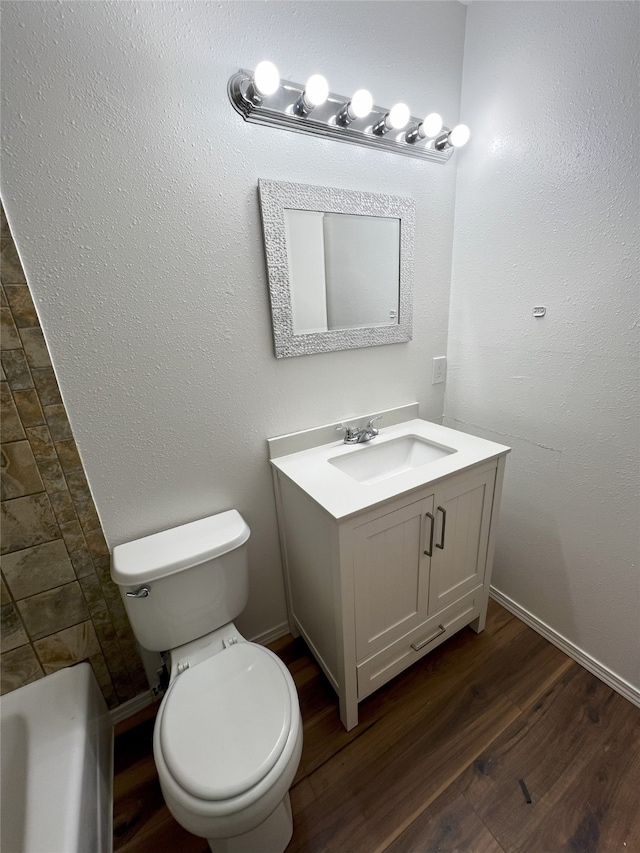 1666 Calle De Oriente Norte, Santa Fe, NM 87507 - bathroom featuring baseboards, toilet, vanity, and wood finished floors