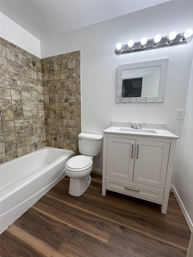 1666 Calle De Oriente Norte, Santa Fe, NM 87507 - full bath with vanity, toilet, baseboards, a textured ceiling, and wood finished floors